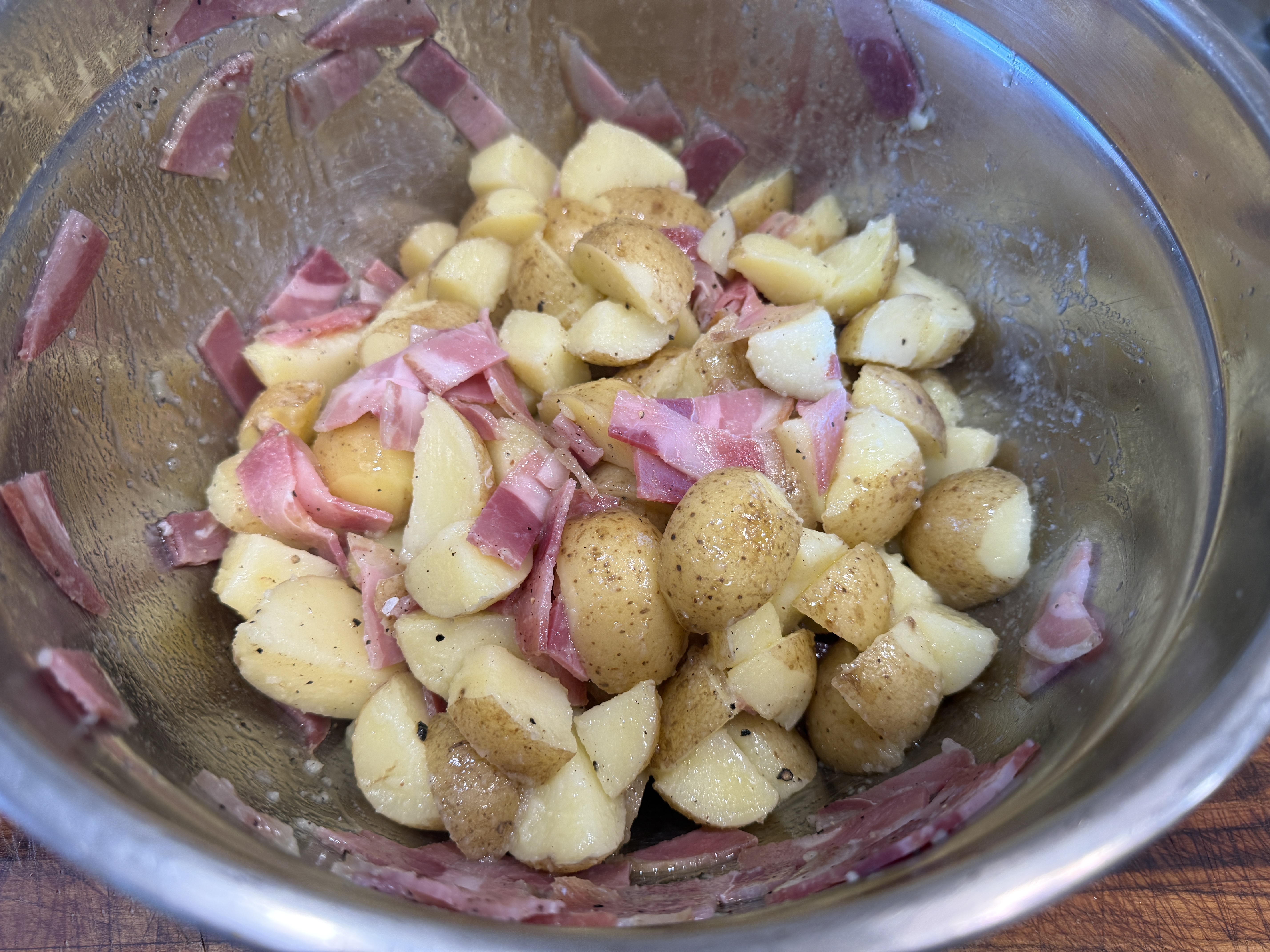 Potato mixture tossed in bowl